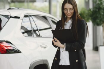 Customer signing paperwork for buy here pay here financing at a Cumming GA used car dealership