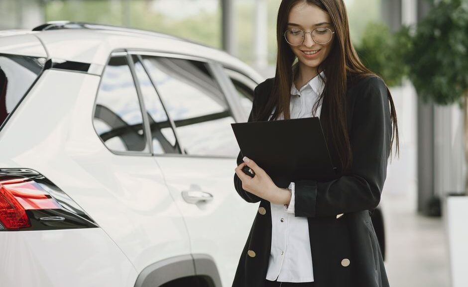 Customer signing paperwork for buy here pay here financing at a Cumming GA used car dealership