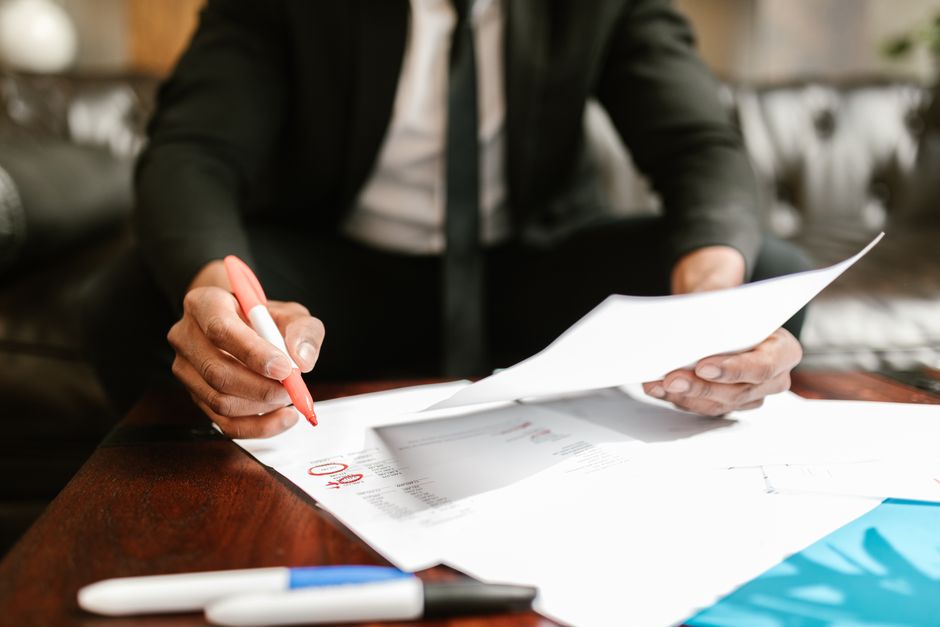 Busy professional reviewing car buying paperwork during a concierge service appointment