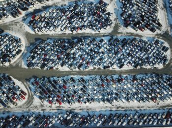 Row of affordable used cars for sale under $10,000 parked on a dealership lot in Cumming GA