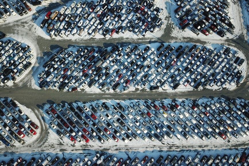 Row of affordable used cars for sale under $10,000 parked on a dealership lot in Cumming GA