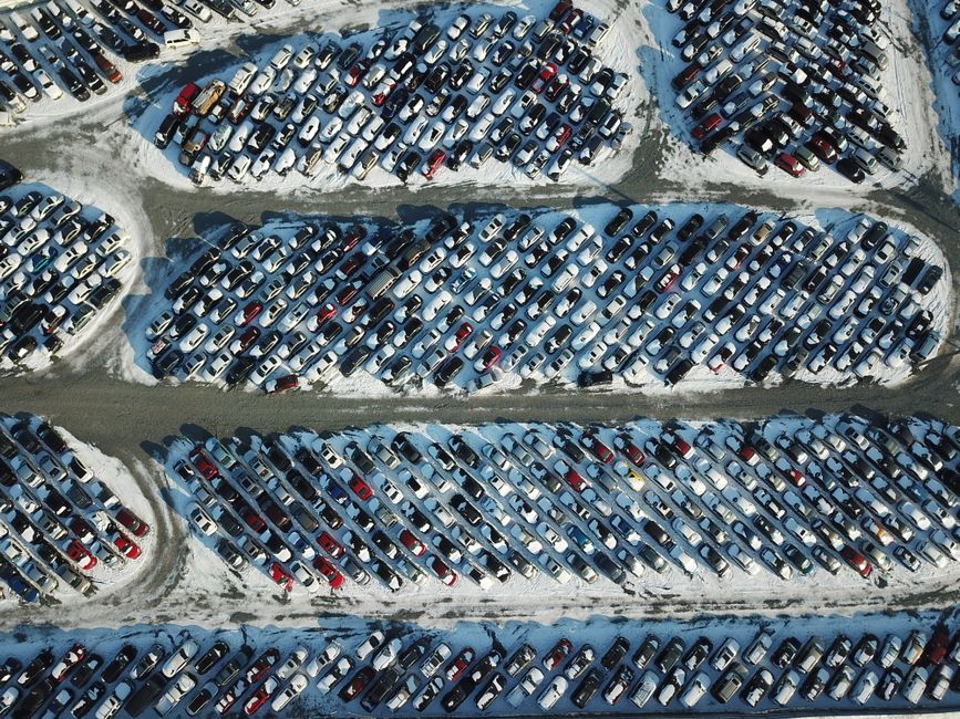 Row of affordable used cars for sale under $10,000 parked on a dealership lot in Cumming GA