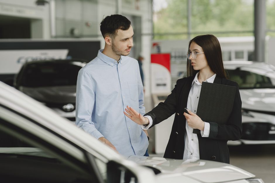 Car buying concierge service advisor helping a customer review vehicle options at a North Georgia dealership