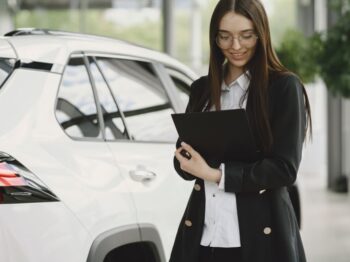 Customer signing paperwork for buy here pay here buy here pay here financing at a Cumming GA used car dealership